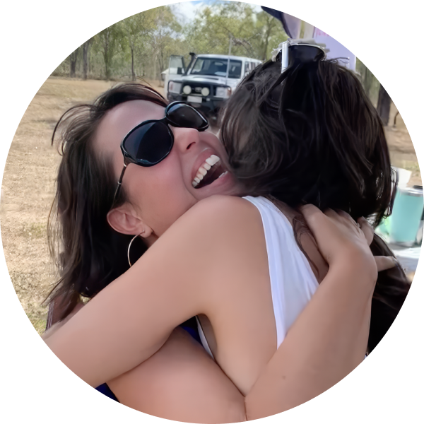 Two female friends hug.