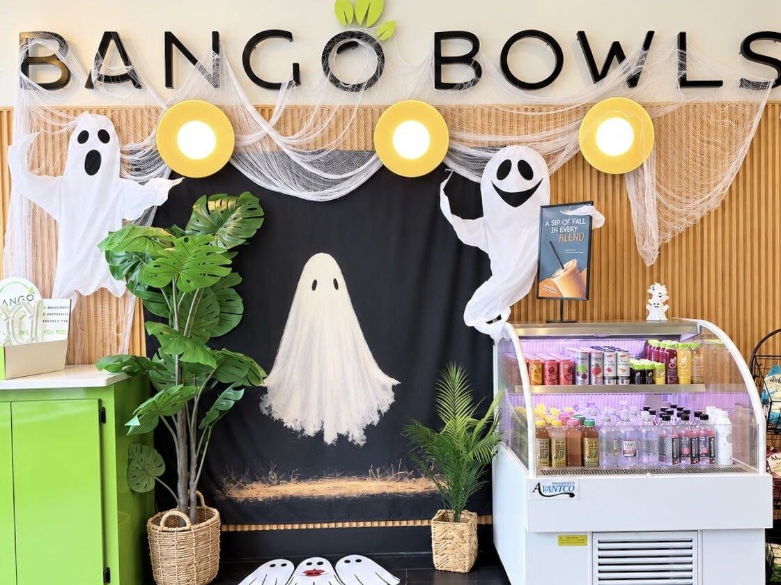 Bango dressed up for Halloween with friendly ghosts under the Bango sign