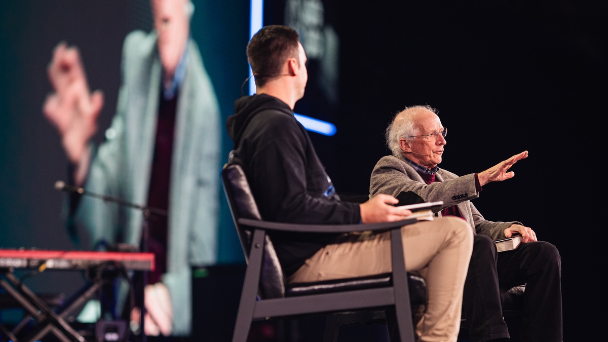 An images of John Piper being interviewed on stage at CROSS CON25.