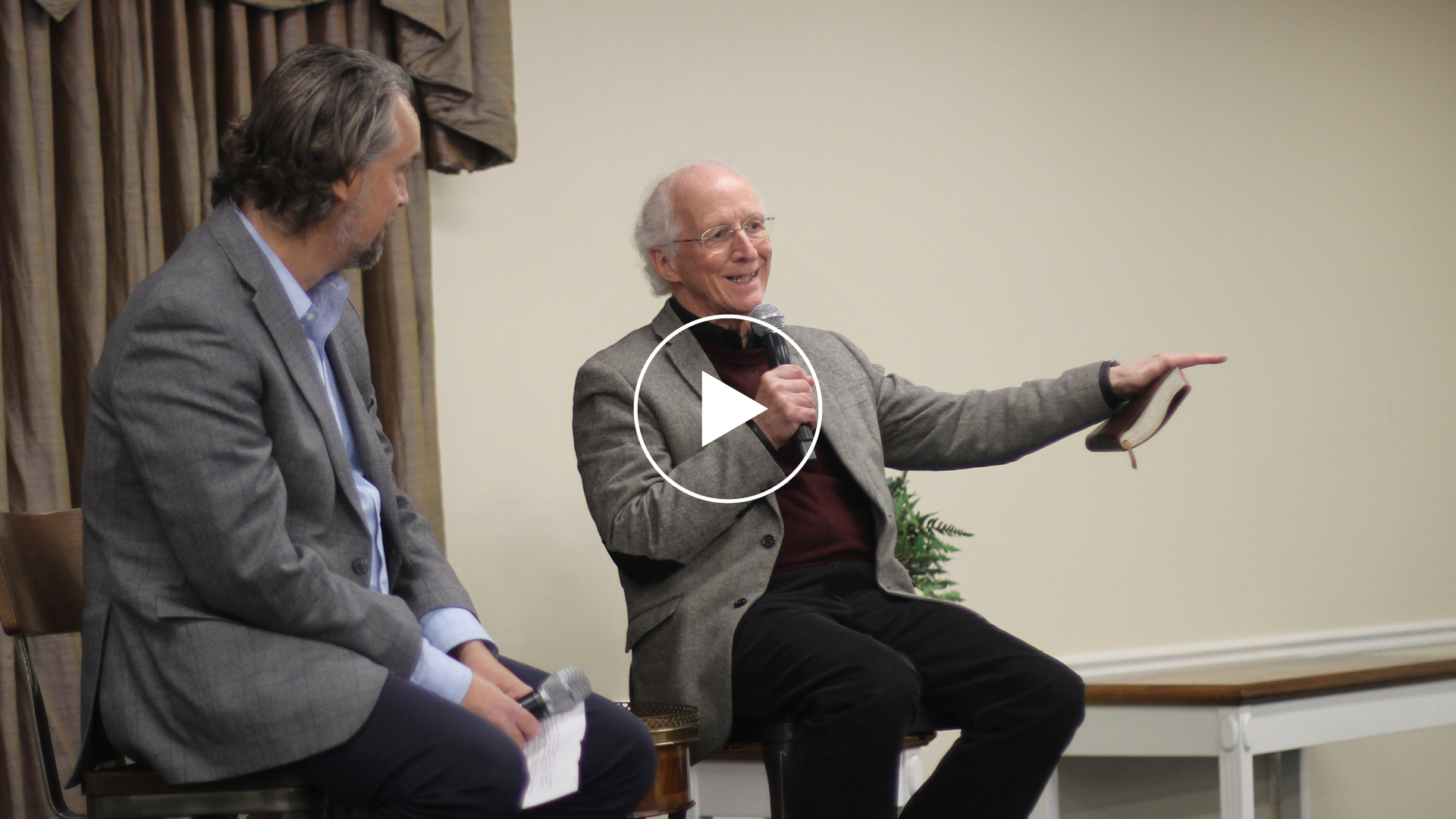 An image of John Piper on stage, addressing a crowd.