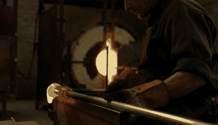 A glassblower turning molten glass, generated by HeyGen Video