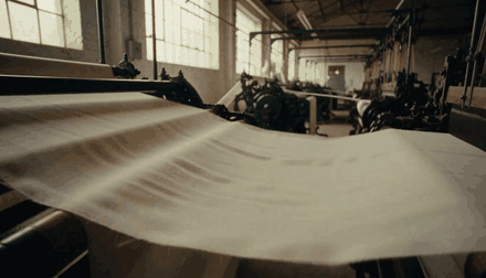 Fabric flowing across an industrial loom, generated by HeyGen Video