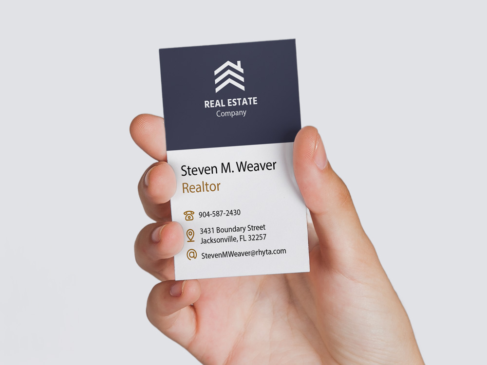 Professional real estate business card featuring company branding, contact information, and a clean modern layout for networking and client meetings.