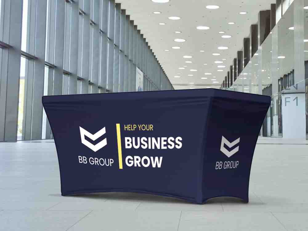 Custom stretch table cover with full-color company branding and promotional messaging, providing a polished display for trade shows, expos, and marketing events.