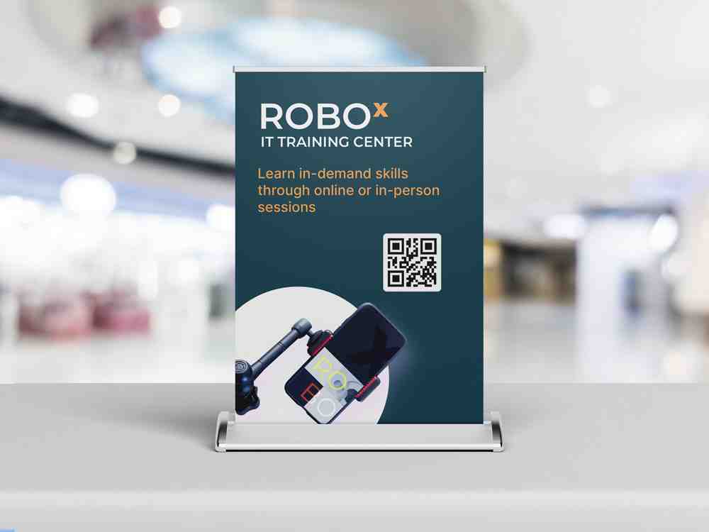 Compact tabletop retractable banner promoting IT training courses with branding, QR code, and course details for reception desks, trade shows, and retail counters.