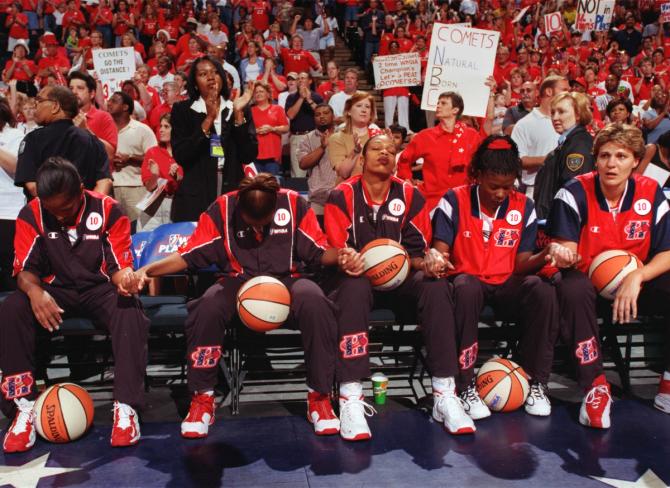 The Houston Comets starting five hold hands in prayer before game two of the 1999 WNBA Western Conference Finals