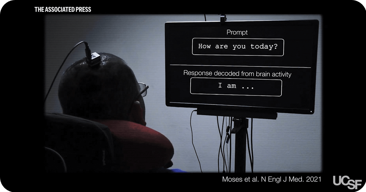 patient looking at a screen with a device attached her brain