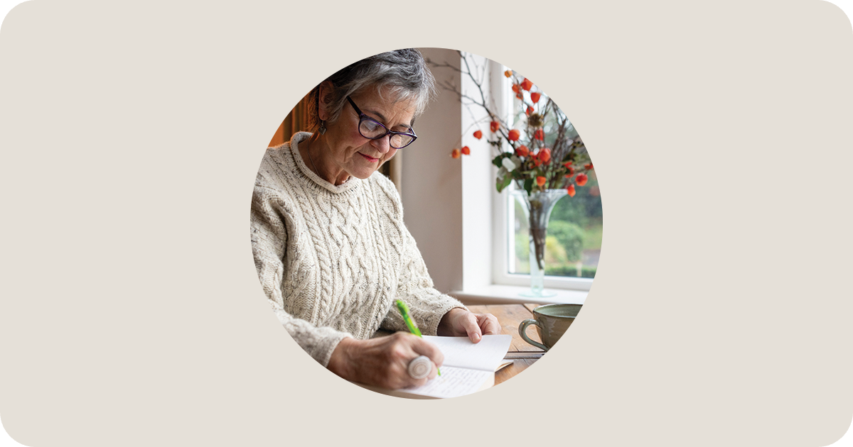 a woman writing in a notebook