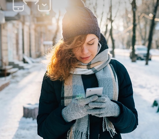 Image of a woman adjusting her home temperature from her car, using the Mysa app